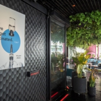 A poster at a nightclub in the Lan Kwai Fong nightlife area of Hong Kong encourages people to get vaccinated . | BLOOMBERG 