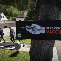 People arrive at a vaccination center at Bran Castle  — purported to be an inspiration for the vampire\'s towering home in Bram Stoker’s novel \"Dracula\"  — in Bran, Romania, on Saturday. | AFP-JIJI