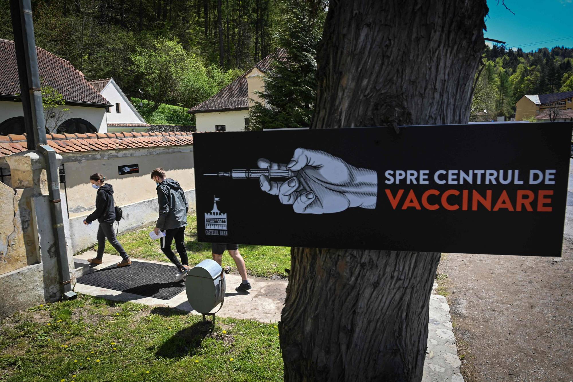 People arrive at a vaccination center at Bran Castle — purported to be an inspiration for the vampire's towering home in Bram Stoker’s novel 
