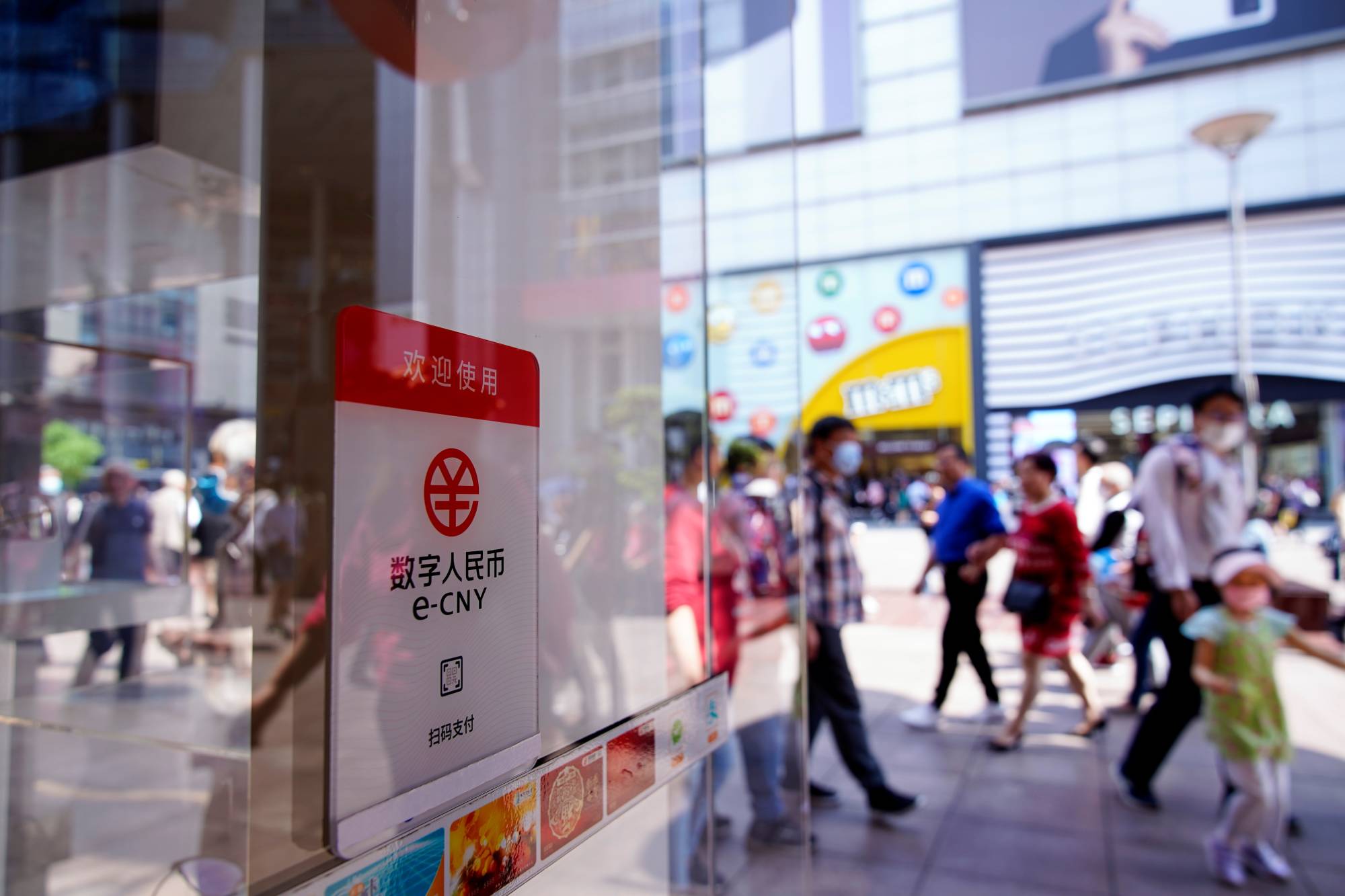 A sign for the digital yuan, also referred to as e-CNY, at a shopping mall in Shanghai | REUTERS 