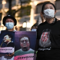Sureerat Chiwarak, mother of arrested anti-government protest leader Parit \"Penguin\" Chiwarak, attends a demonstration in Bangkok in April demanding his release. | REUTERS 