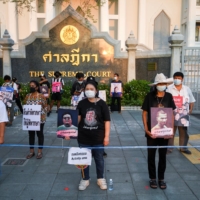 The mothers of arrested anti-government protest leaders demand the release of their sons outside Remand prison in Bangkok on April 28.  | REUTERS 
