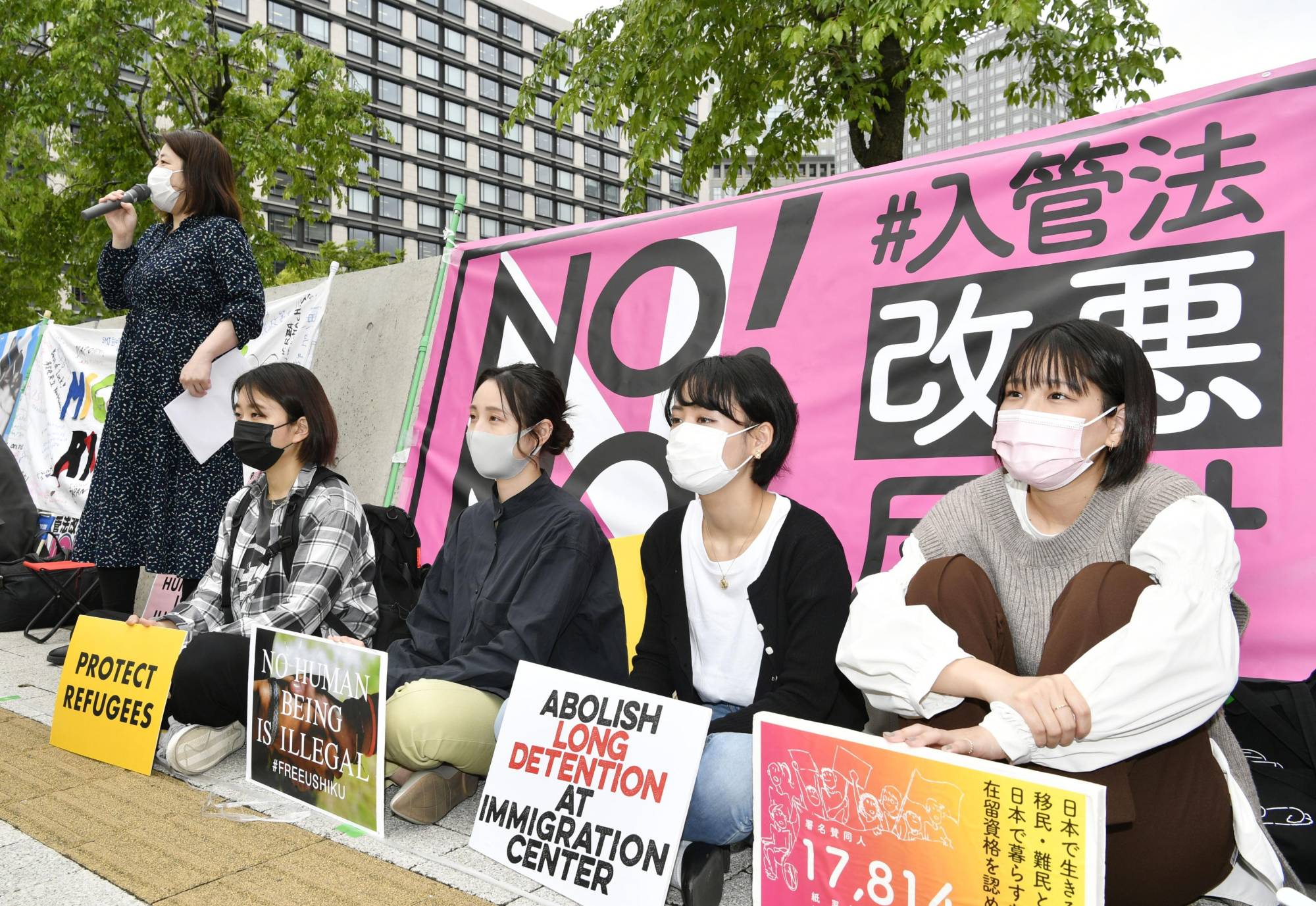 Protesters stage a sit-in rally near the Diet in Tokyo on May 7 against a bill to revise the immigration law. | KYODO