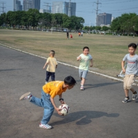 Children play soccer in Humen Park in Dongguan, China, in March. China’s census released Tuesday shows that amid the uncertainties of the coronavirus pandemic last year, the number of births nationwide fell to the lowest level since 1961 | LORENZ HUBER / THE NEW YORK TIMES