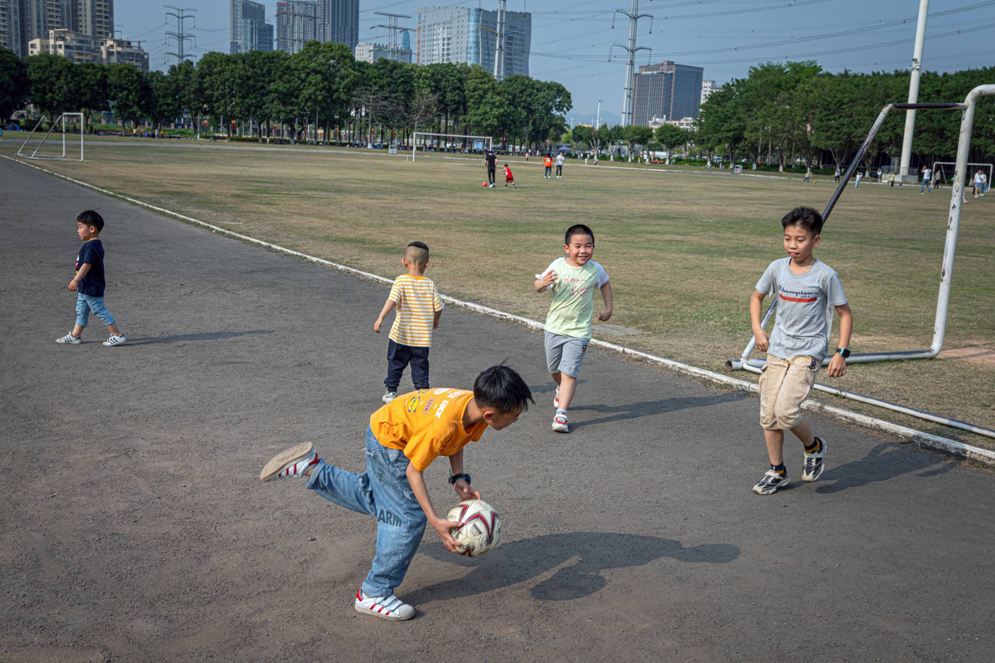 Children play soccer in Humen Park in Dongguan, China, in March. China’s census released Tuesday shows that amid the uncertainties of the coronavirus pandemic last year, the number of births nationwide fell to the lowest level since 1961 | Lorenz Huber / The New York Times
