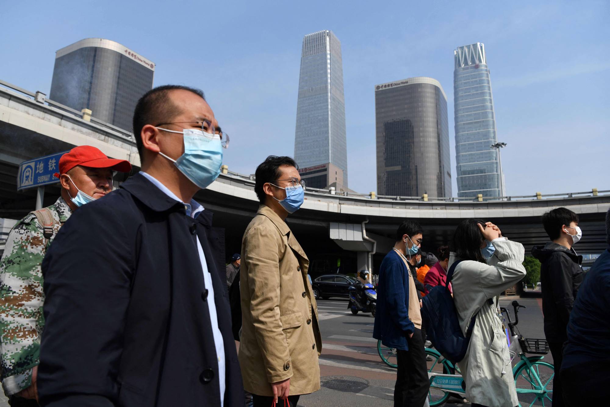 Commuters in Beijing on Tuesday morning. China will need to defy a regional trend, where declining fertility rates have tended to coincide with slow or stagnant economic growth. | AFP-JIJI