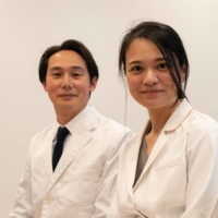 Clinic director Rie Mitsui and her husband, Toshikatsu, sit in the waiting room at Muza Kawasaki Pediatric Clinic in Kawasaki, Kanagawa Prefecture, in May. Toshikatsu, who was formerly a vaccine researcher at Keio University School of Medicine\'s pediatrics department, joined his wife after she opened the clinic in 2016. | ROB GILHOOLY