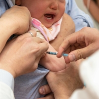 A baby has a routine vaccination at Muza Kawasaki Pediatric Clinic in Kawasaki, Kanagawa Prefecture. | ROB GILHOOLY