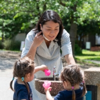 Kaoru Suzuki-Houghton plays with her 2-year-old twin daughters, Sophia and Malia, at a park in Tokyo in April. | ROB GILHOOLY