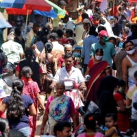 Crowds fill a marketplace in a Mumbai slum in April. | REUTERS