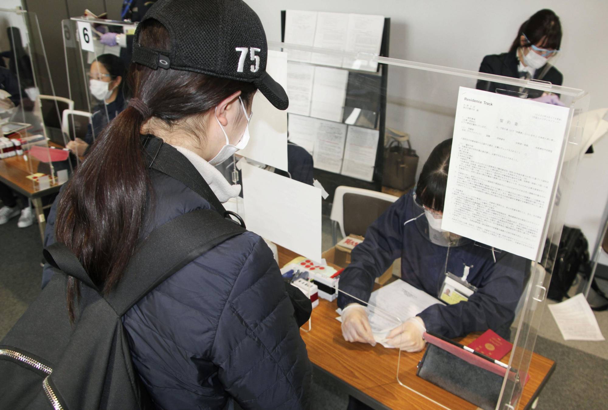 An arriving passenger submits test certificates at Narita Airport in Chiba Prefecture on April 19. | KYODO
