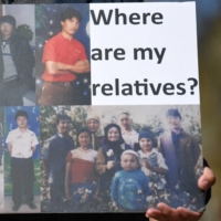 A member of the Uyghur community joins a demonstration in London in April to call on the British Parliament to vote to recognize the persecution of China\'s Muslim minority as genocide and crimes against humanity.
 | AFP-JIJI