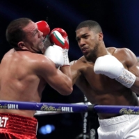 Anthony Joshua punches Kubrat Pulev during their heavyweight world title fight in London on Dec. 12, 2020. | POOL / VIA REUTERS
