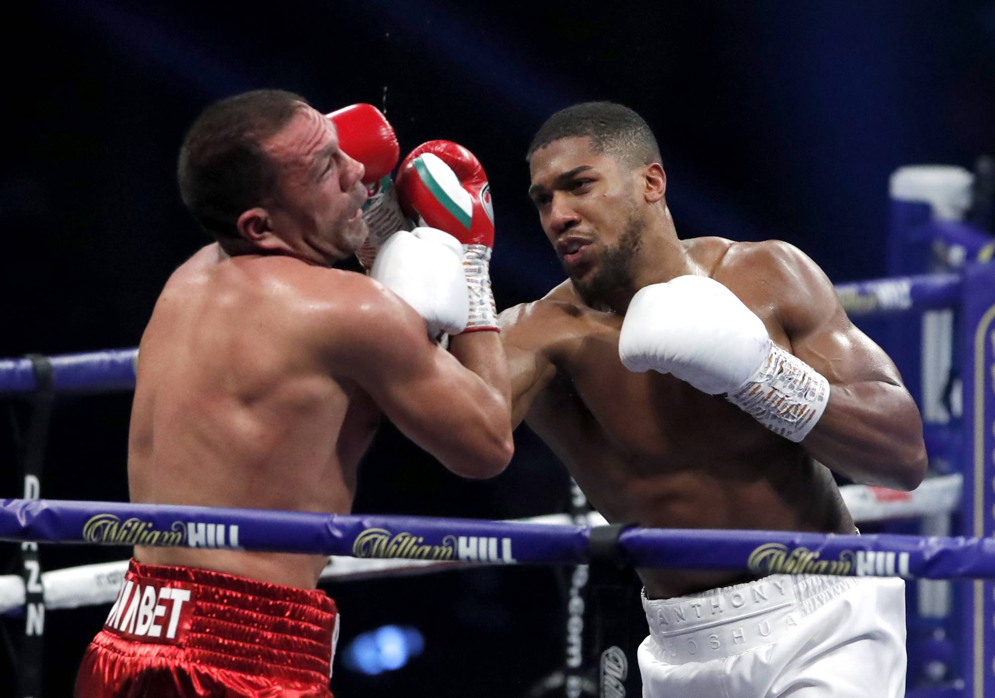 Anthony Joshua punches Kubrat Pulev during their heavyweight world title fight in London on Dec. 12, 2020. | POOL / VIA REUTERS