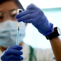 Japan has signed a contract with U.S. pharmaceutical giant Pfizer Inc. to receive additional doses of its coronavirus vaccine for 25 million people by September, health minister Norihisa Tamura said Friday. | POOL / VIA REUTERS