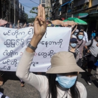 Protesters make a three-finger salute during a demonstration against the military coup in Yangon, Myanmar, on Friday. | AFP-JIJI