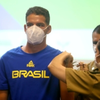 Brazilian athletes and staff traveling to Tokyo for the Summer Olympics receive the COVID-19 vaccine in Rio de Janeiro on Friday. | REUTERS