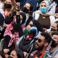 People raise their fists as thousands gather during a rally in support of Palestinians in Boston on Saturday.  | AFP-JIJI