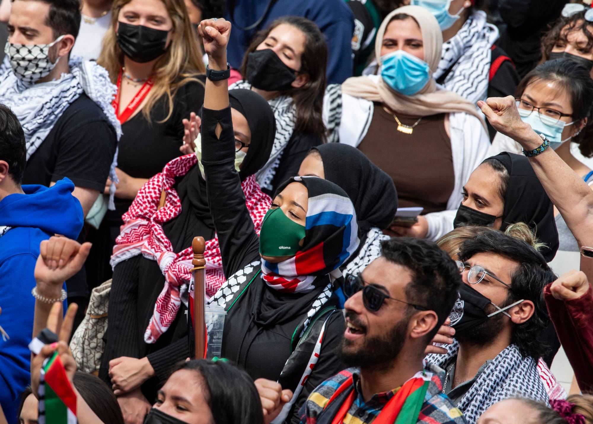 People raise their fists as thousands gather during a rally in support of Palestinians in Boston on Saturday. | AFP-JIJI
