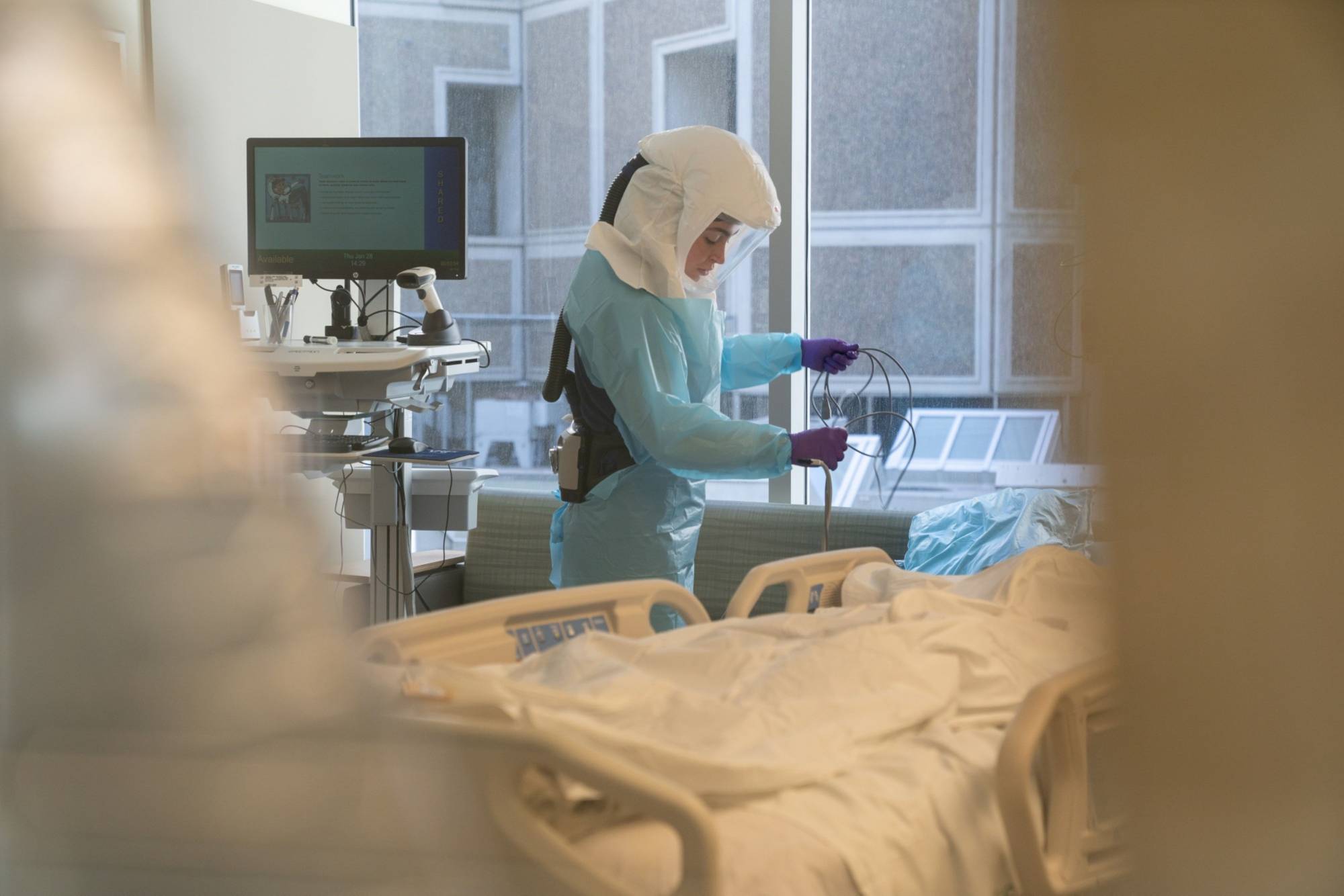 A worker disinfects a room after a COVID-19 patient departed at Sharp Memorial Hospital in San Diego in January.  | BLOOMBERG