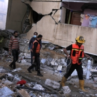 A building turned to rubble after an Israeli airstrike in Gaza City on Sunday.  | SAMAR ABU ELOUF / THE NEW YORK TIMES