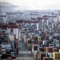 Containers ready for shipment are stacked at the Yangshan Deepwater Port in Shanghai. China is pushing ahead with behind-the-scenes talks to join a major trade pact in the Asia-Pacific. | BLOOMBERG