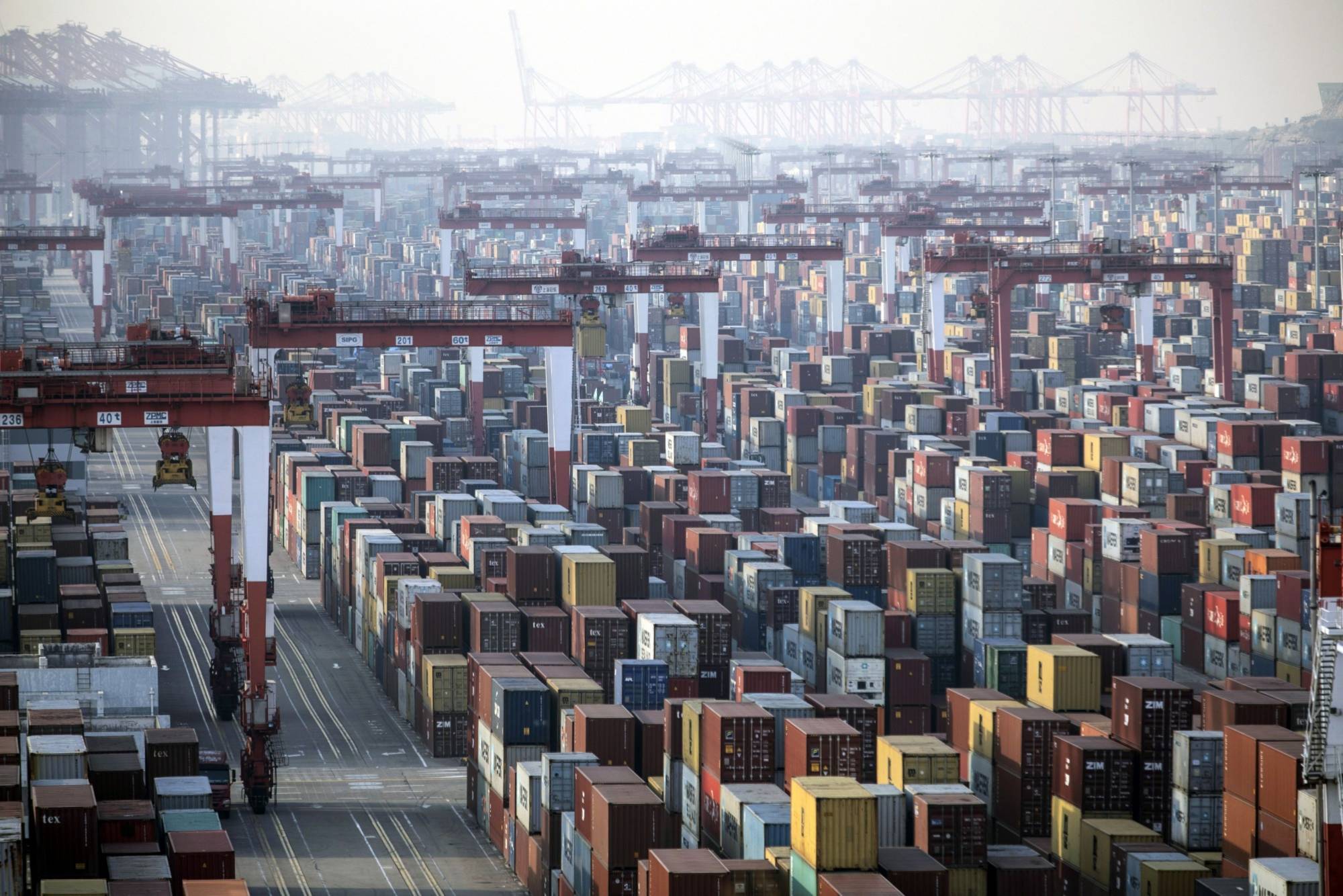 Containers ready for shipment are stacked at the Yangshan Deepwater Port in Shanghai. China is pushing ahead with behind-the-scenes talks to join a major trade pact in the Asia-Pacific. | BLOOMBERG