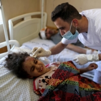 A 6-year-old Palestinian girl is treated by a medic at a hospital after being pulled from the rubble of a building amid Israeli air strikes, in Gaza City on Sunday. | REUTERS 