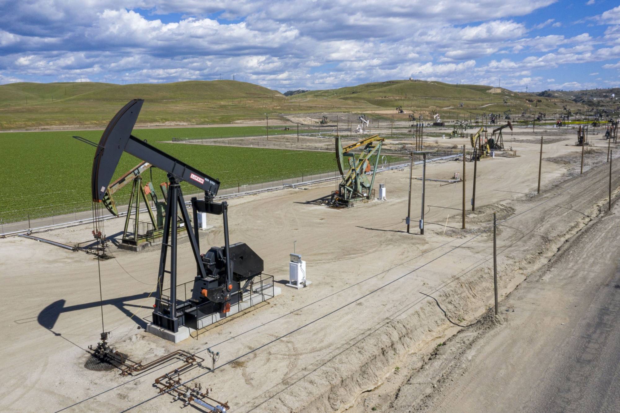 Oil well pump jacks operated by Chevron Corp. in San Ardo, California | BLOOMBERG 
