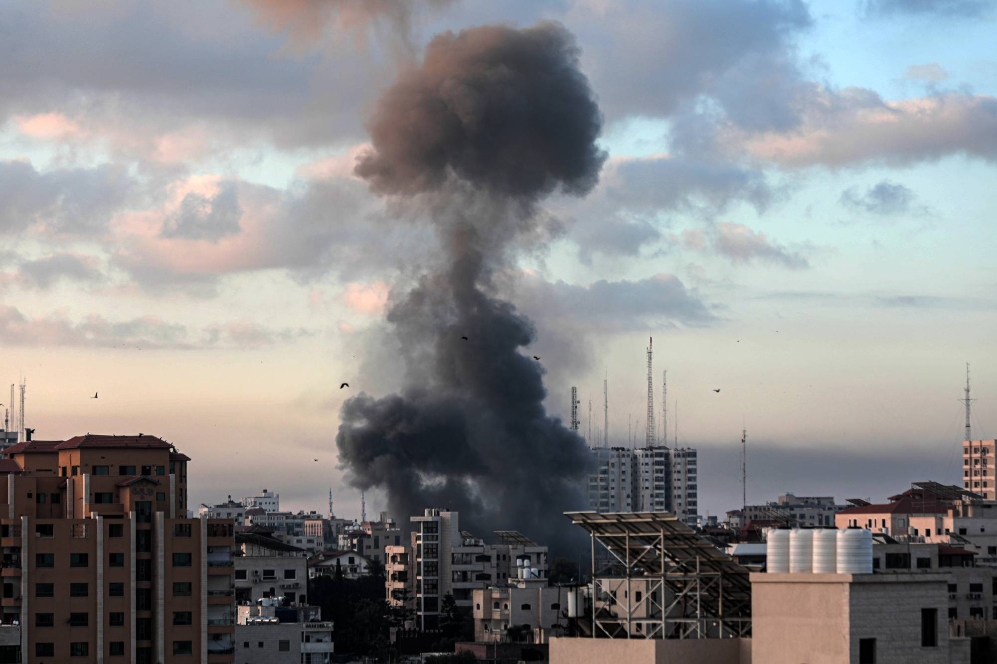 Smoke rises from a building in Gaza City, Gaza Strip, on Tuesday following an Israeli airstrike. | Hosam Salem / The New York Times