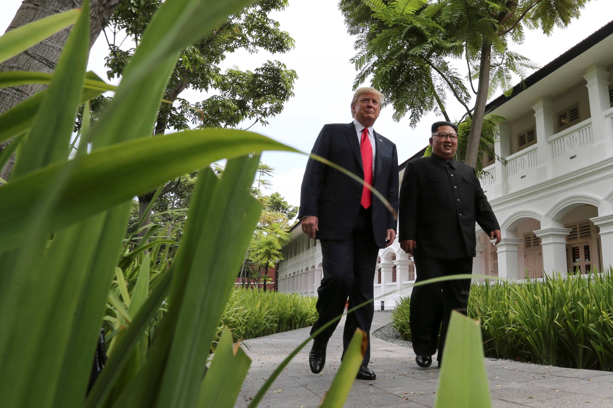 U.S. President Donald Trump and North Korea's leader Kim Jong Un before a working lunch during their summit in Singapore in June 2018. | Reuters 