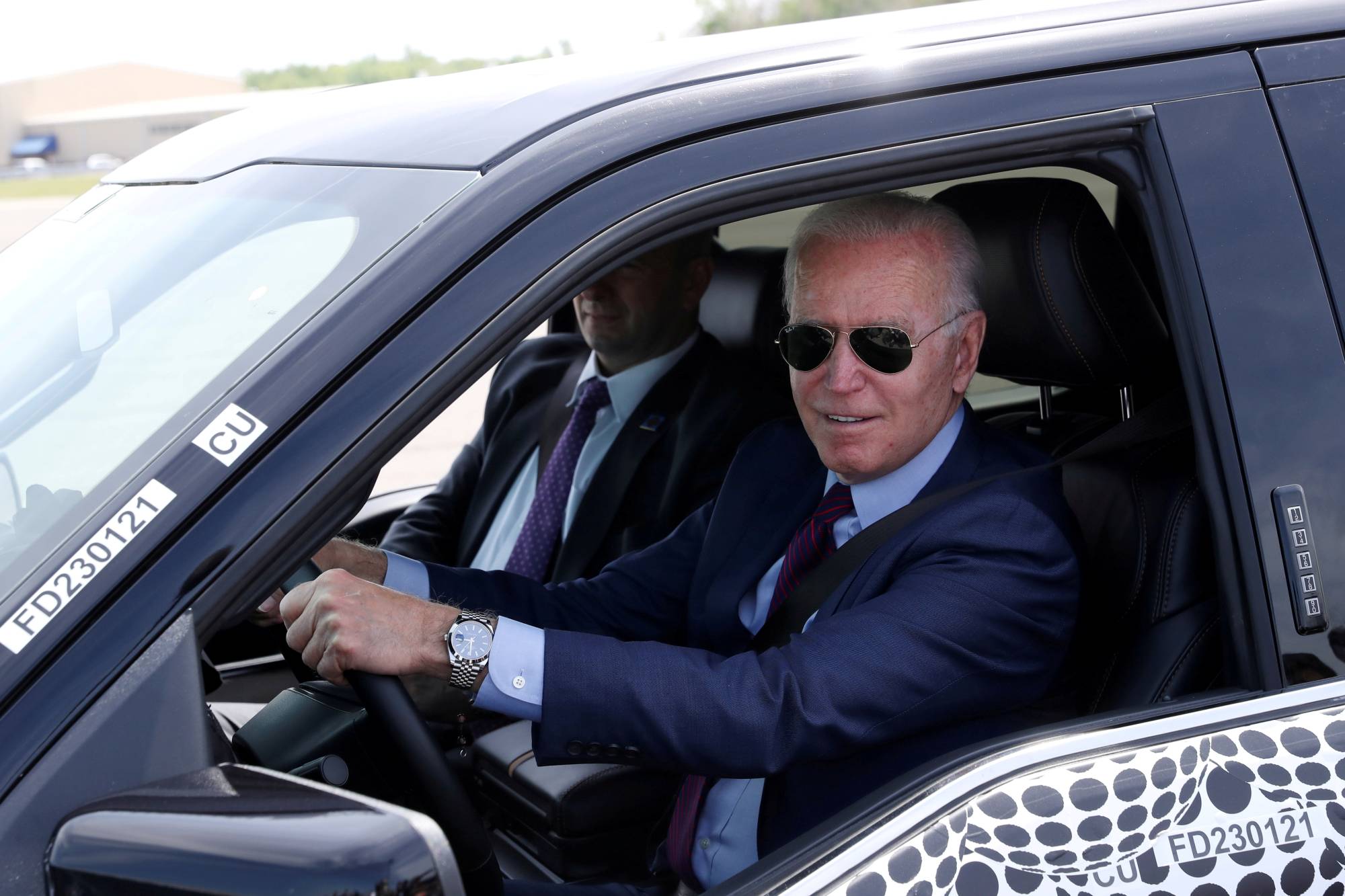 U.S. President Joe Biden tests the new Ford F-150 Lightning truck on Tuesday. | Reuters 