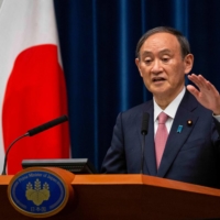Prime Minister Yoshihide Suga speaks during a news conference in Tokyo on May 14. | POOL / VIA AFP-JIJI