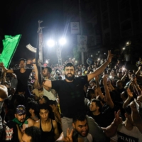 Palestinians celebrate in the streets following a ceasefire brokered by Egypt between Israel and the ruling Islamist movement Hamas in the Gaza Strip, on Friday in Gaza City. | AFP-JIJI