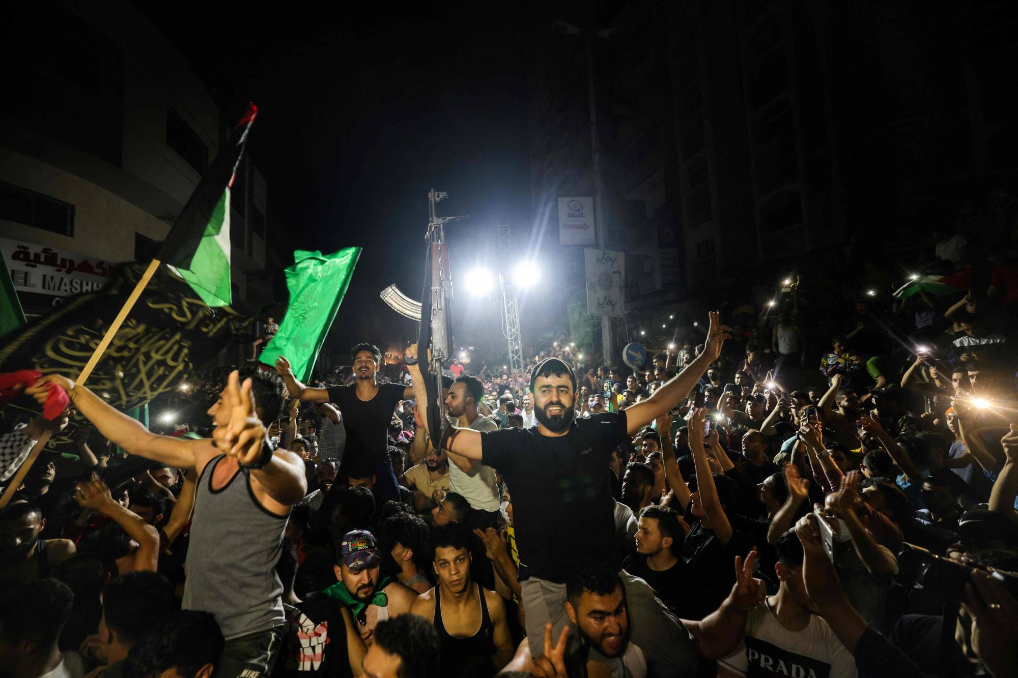 Palestinians celebrate in the streets following a ceasefire brokered by Egypt between Israel and the ruling Islamist movement Hamas in the Gaza Strip, on Friday in Gaza City. | AFP-JIJI