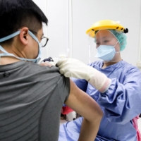 A nurse administers a dose of the AstraZeneca COVID-19 vaccine at Chang Gung Memorial Hospital in Taipei on May 13. | BLOOMBERG 