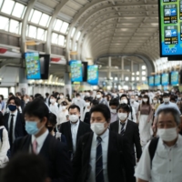 While younger people are being blamed by some media outlets for the spread of COVID-19, adults and older residents continue to crowd the capital\'s train stations each morning and evening. | RYUSEI TAKAHASHI
