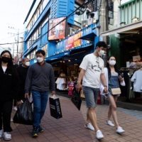 People in South Korea who have had one dose of a COVID-19 vaccine will be able to go about their daily lives without the need to wear face masks from July. | BLOOMBERG