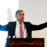 Former Nissan chairman Carlos Ghosn gestures as he speaks during a news conference in Beirut in January 2020. | REUTERS