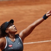 Naomi Osaka serves against Jessica Pegula during the second round of the Italian Open in Rome on May 12. | REUTERS