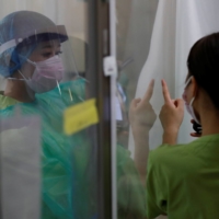 COVID-19 infections are declining in some areas including Tokyo and Osaka but \"on the whole the situation is highly unpredictable,\" Prime Minister Yoshihide Suga said. | REUTERS 