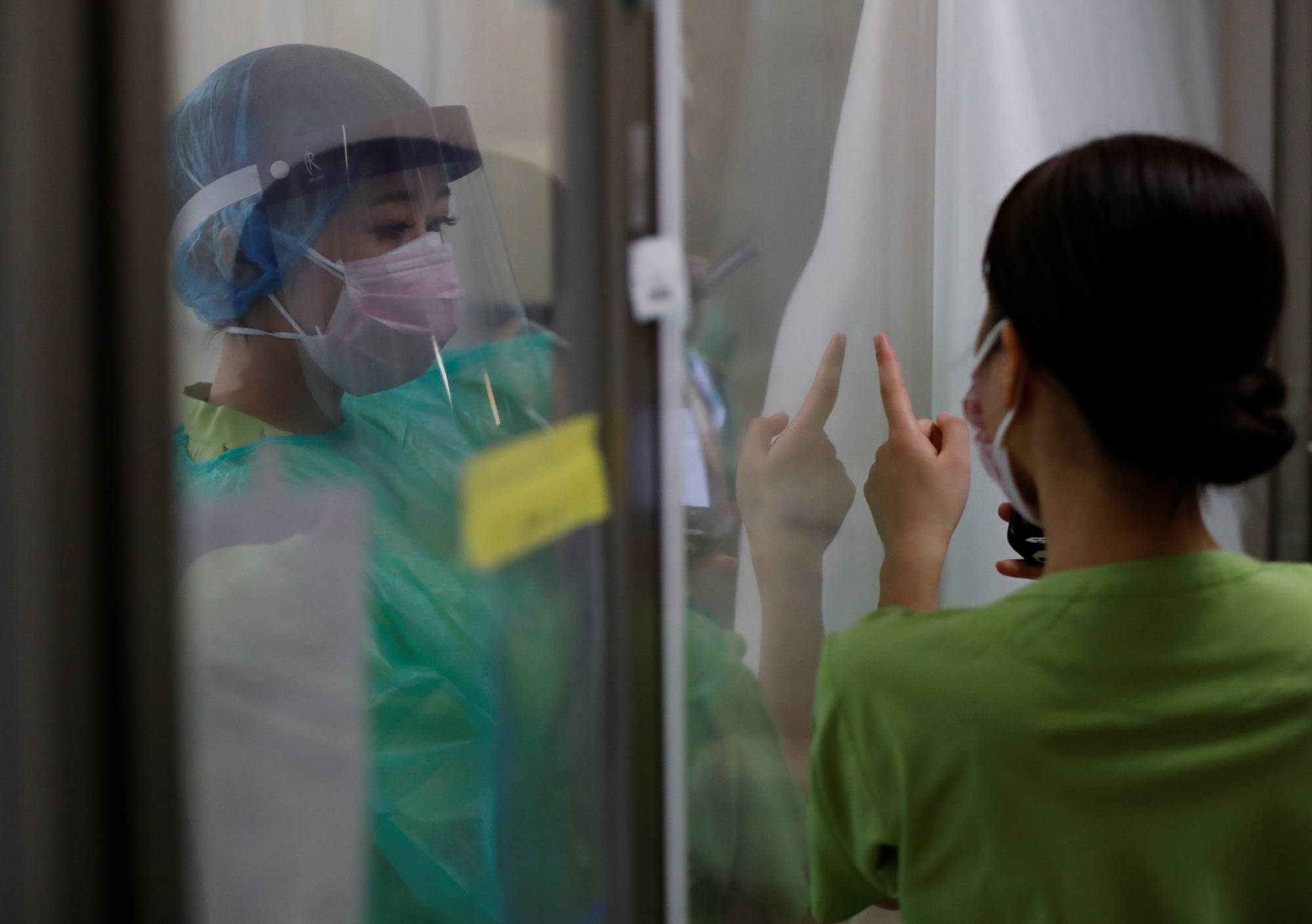 COVID-19 infections are declining in some areas including Tokyo and Osaka but 'on the whole the situation is highly unpredictable,' Prime Minister Yoshihide Suga said. | REUTERS 