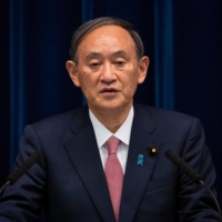 Prime Minister Yoshihide Suga speaks during a news conference in Tokyo on May 14. | POOL / VIA AFP-JIJI