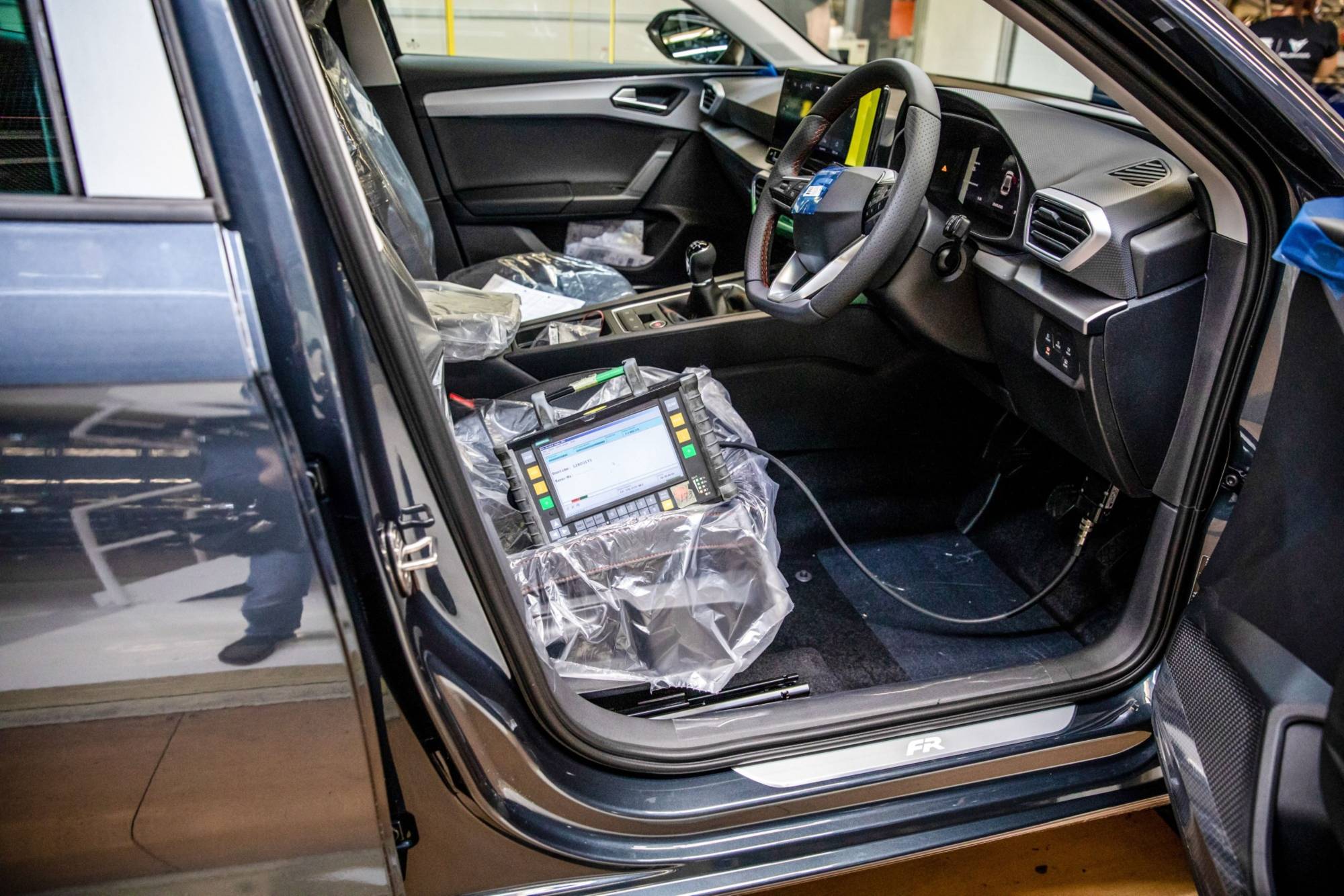 A computer sits plugged into a Cupra Formentor automobile on the production line at the Seat SA, a unit of Volkswagen AG, at its Martorell plant near Barcelona. | Bloomberg 