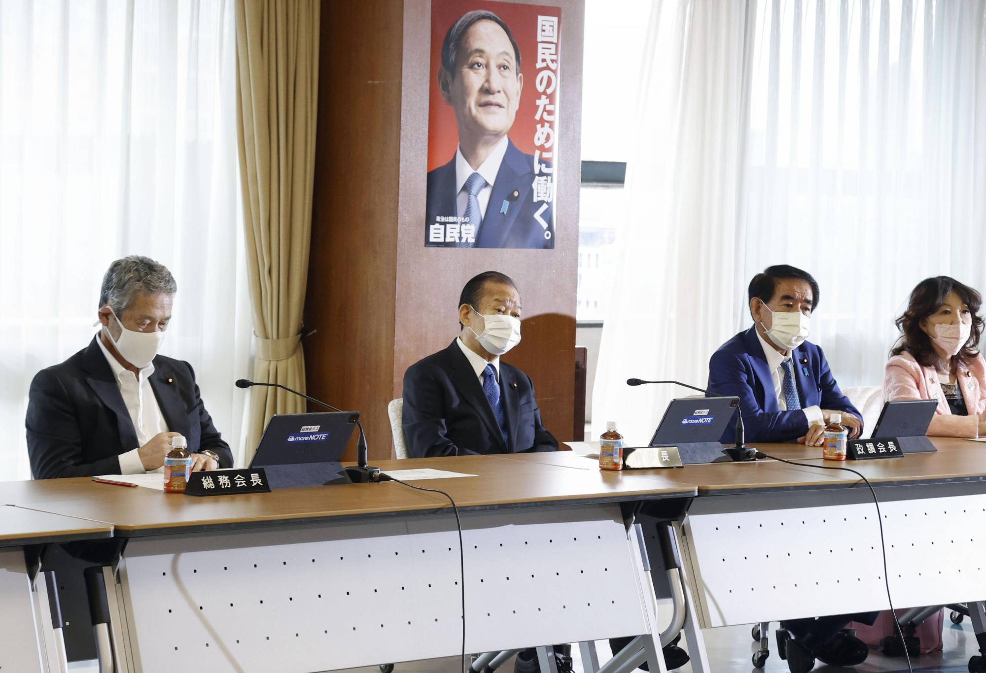 Tsutomu Sato (left) and other lawmakers attend a meeting of the Liberal Democratic Party's General Council at the party's headquarters in Tokyo on Friday.  | REUTERS