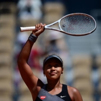 Naomi Osaka celebrates after beating Patricia Maria Tig in the first round of the French Open in Paris on Sunday. | AFP-JIJI