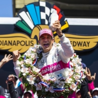 Helio Castroneves celebrates after winning the Indianapolis 500 at Indianapolis Motor Speedway on Sunday.  | USA TODAY / VIA REUTERS