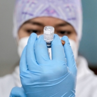 A health care worker prepares a dose of the Pfizer-BioNTech COVID-19 vaccine in Quito, Ecuador.  | REUTERS