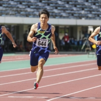 Ryota Yamagata (center) sets a new national record in the 100-meter sprint during a race on Sunday in Tottori. | POOL / VIA KYODO