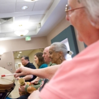 A music therapist plays a drum with Alzheimer\'s disease patients at the Copper Ridge Care Center in Sykesville, Maryland.  | AFP-JIJI